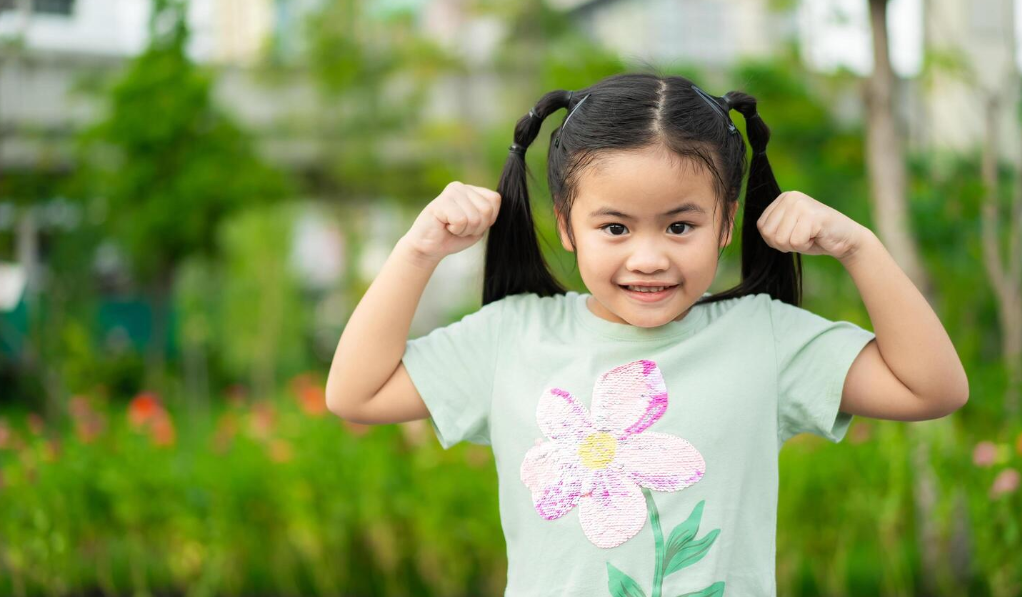 good health concept strong asian little girl raising hands up and smiling portrait of happy child isolated on park background 49631635 stock photo at vecteezy 07 23 2025 07 29 pm