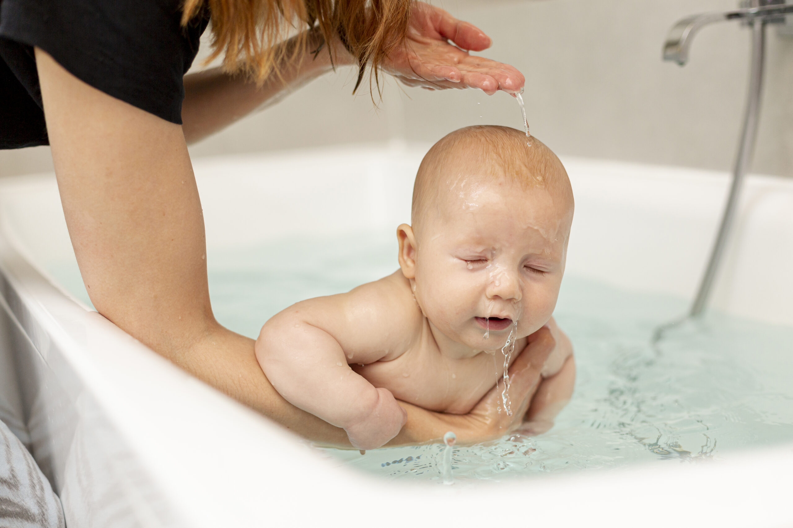 mother washing her baby