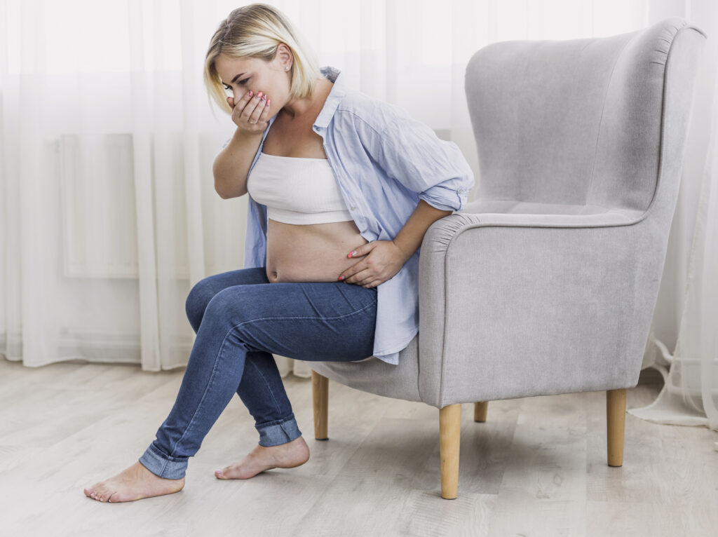 pregnant woman having morning sickness