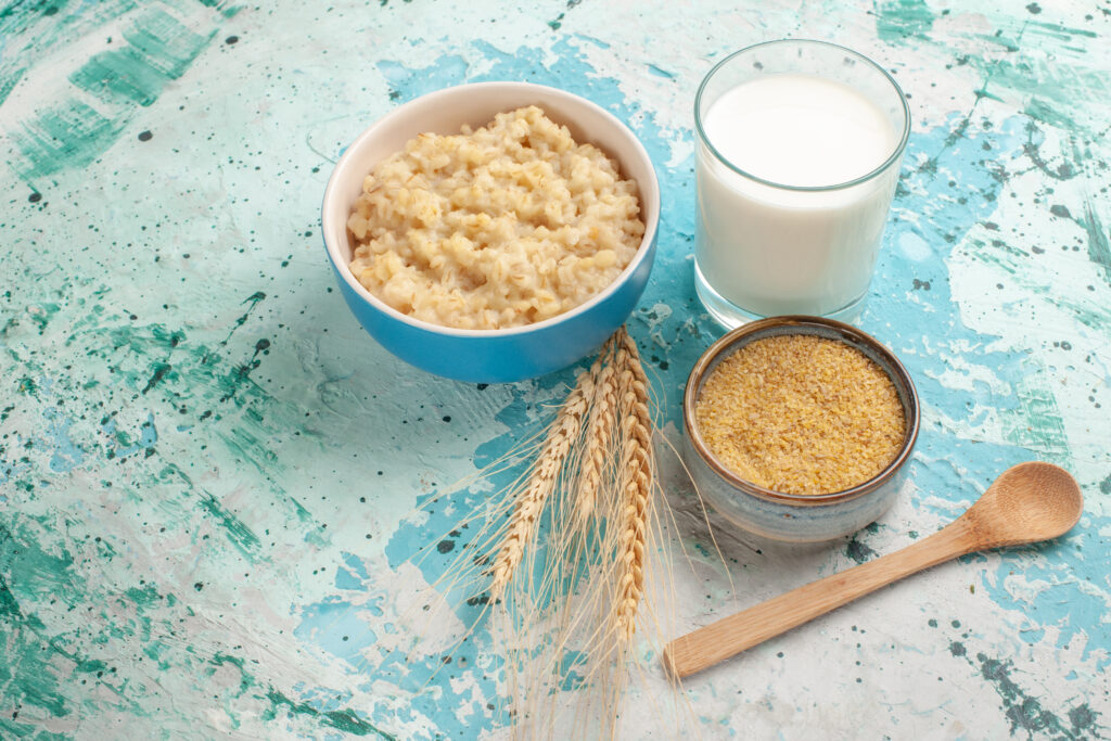 front view tasty porridge with milk blue desk breakfast meal food milk