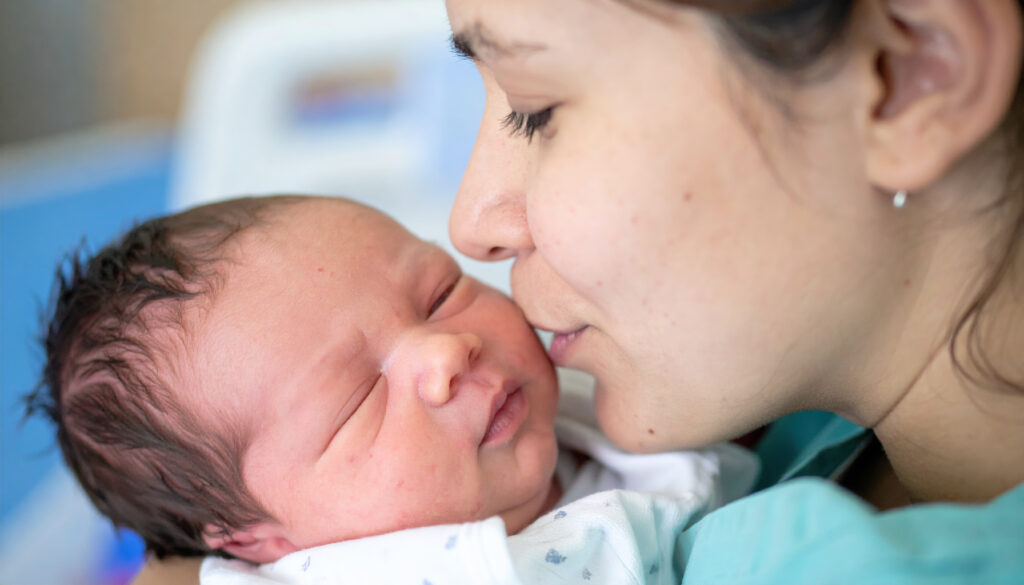 mother tender kiss rests on her newborn son cheek, testament to their unwavering bond and love