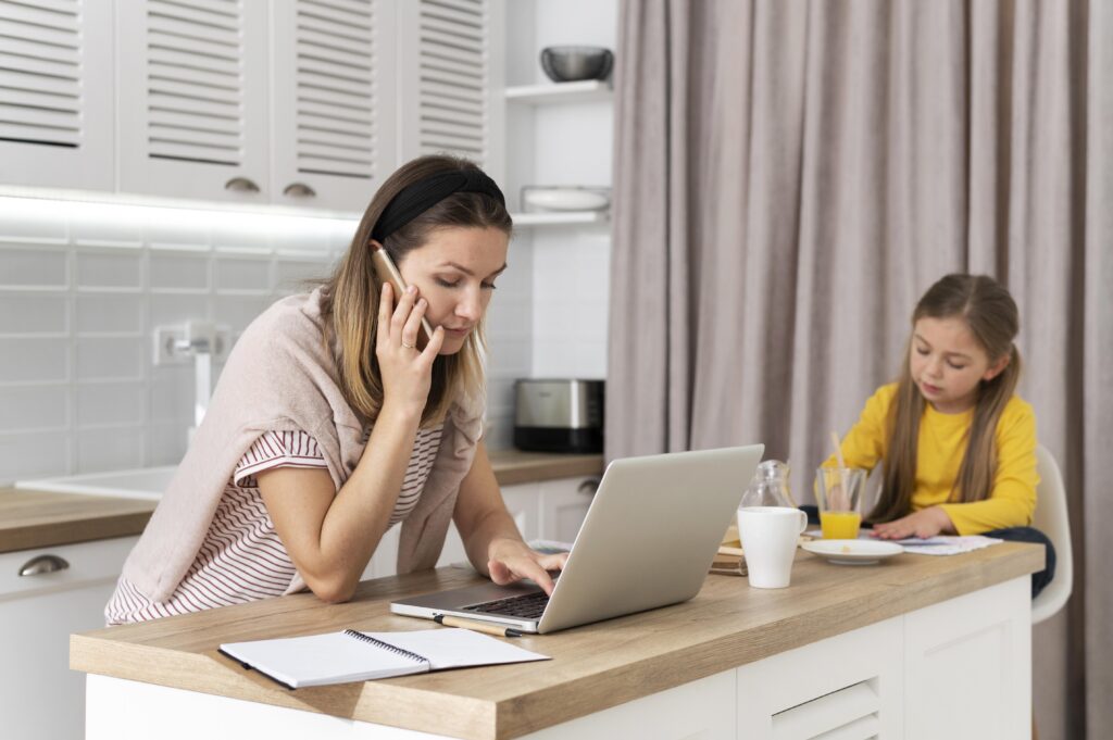 woman working remotely with kid